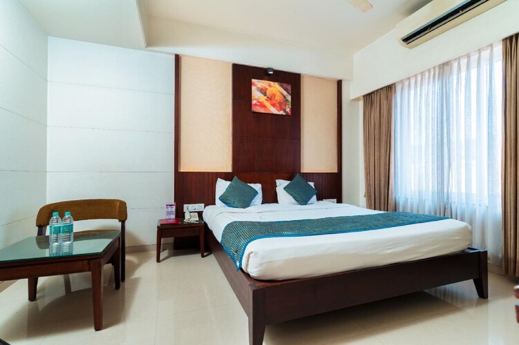 Deluxe Room at Hotel Chaitali showing the bed and window
